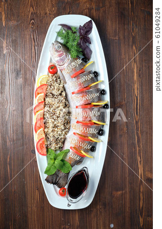Stuffed fish with vegetables and rice. catering menu Stuffed fish with vegetables and rice. catering menu 61049284