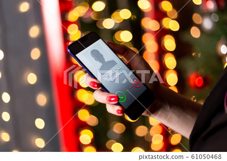 Phone call from unknown number. Scam, fraud or phishing with smartphone concept. Prank caller, scammer or stranger. Woman answering to incoming call. Hoax person with fake identity 61050468