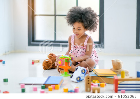 One young African little girls play toys and look fun and enjoy 61052063