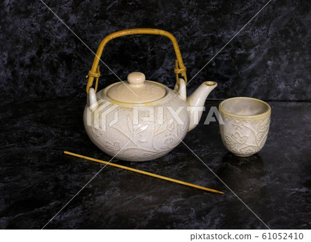 Stack of antique ceramic cups, teapot on a white background.vintage Stack of antique ceramic cups, teapot on a white background.vintage 61052410