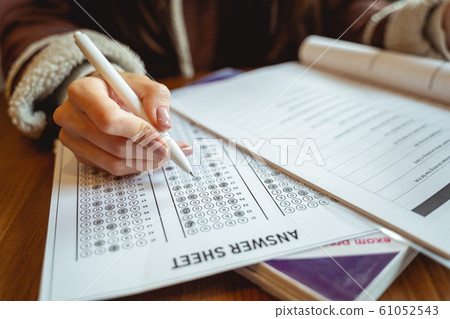 Young female person completing task before exams 61052543