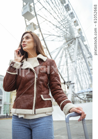 Cheerful young woman waiting for her friend Cheerful young woman waiting for her friend 61052668