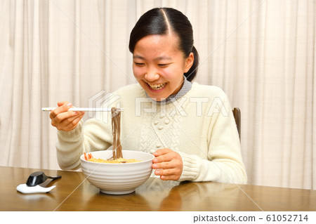Girl eating New Year's Eve Soba (New Year's Eve) Girl eating New Year's Eve Soba (New Year's Eve) 61052714