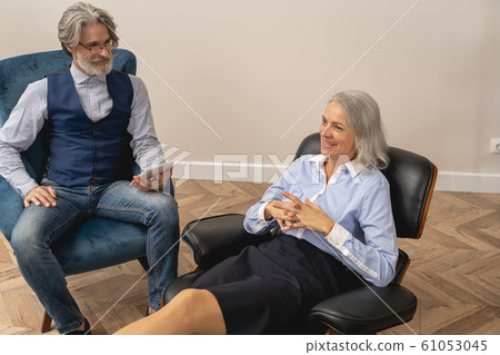 Cheerful lady laughing in a psychoanalysts office 61053045
