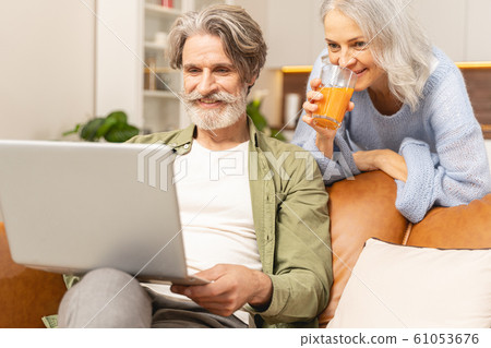 Smiling Caucasian male looking at his computer Smiling Caucasian male looking at his computer 61053676