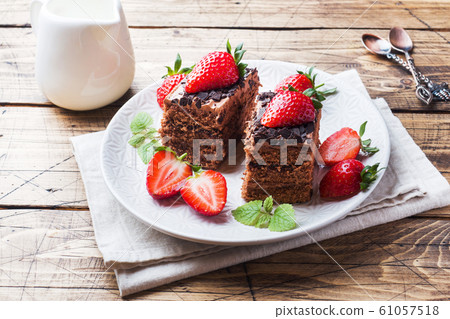 Chocolate truffle cake with strawberries and mint. Chocolate truffle cake with strawberries and mint. 61057518