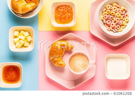 Coffee and croissants on a bright trendy Coffee and croissants on a bright trendy 61061208