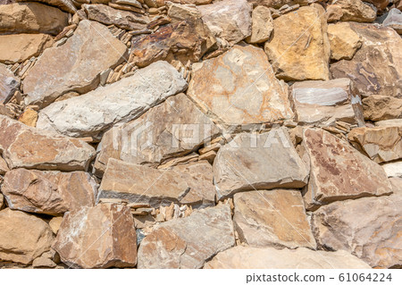texture of wall from a natural stone, background texture of wall from a natural stone, background 61064224