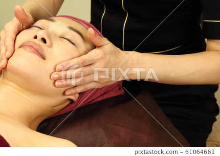 A woman receiving facial beauty A woman receiving facial beauty 61064661