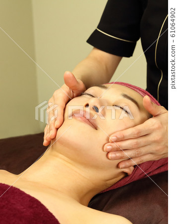 A woman receiving facial beauty 61064902