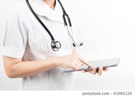 Young asian nurse with a stethoscope using a digital tablet, isolated over white background. 61065128