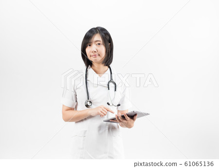 Young asian nurse with a stethoscope using a digital tablet, isolated over white background. 61065136