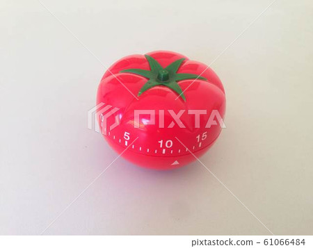 Pomodoro Timer red with green details. Tomato on the table. Vibrant, multi-angle colors. 61066484