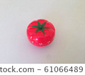 Pomodoro Timer red with green details. Tomato on the table. Vibrant, multi-angle colors. 61066489