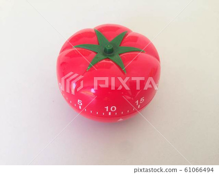 Pomodoro Timer red with green details. Tomato on the table. Vibrant, multi-angle colors. 61066494