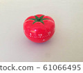 Pomodoro Timer red with green details. Tomato on the table. Vibrant, multi-angle colors. 61066495