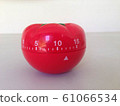 Pomodoro Timer red with green details. Tomato on the table. Vibrant, multi-angle colors. 61066534
