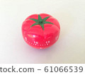 Pomodoro Timer red with green details. Tomato on the table. Vibrant, multi-angle colors. 61066539