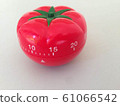Pomodoro Timer red with green details. Tomato on the table. Vibrant, multi-angle colors. 61066542