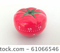 Pomodoro Timer red with green details. Tomato on the table. Vibrant, multi-angle colors. 61066546