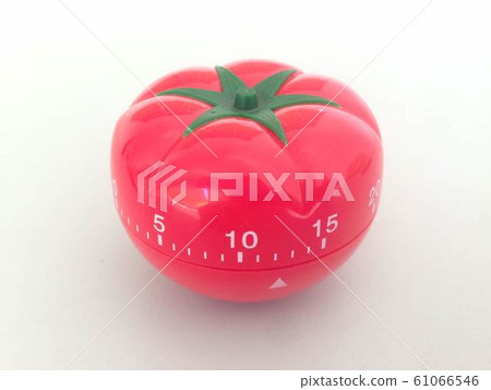 Pomodoro Timer red with green details. Tomato on the table. Vibrant, multi-angle colors. 61066546