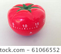 Pomodoro Timer red with green details. Tomato on the table. Vibrant, multi-angle colors. 61066552