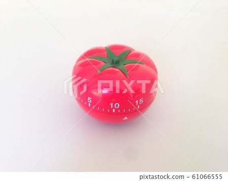 Pomodoro Timer red with green details. Tomato on the table. Vibrant, multi-angle colors. 61066555