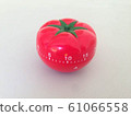 Pomodoro Timer red with green details. Tomato on the table. Vibrant, multi-angle colors. 61066558
