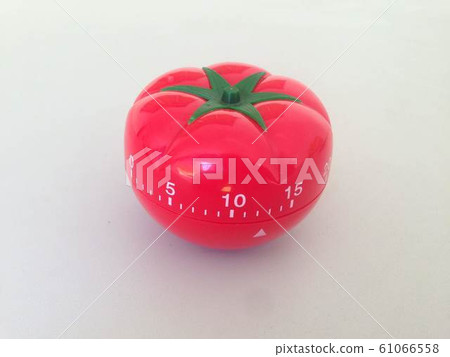Pomodoro Timer red with green details. Tomato on the table. Vibrant, multi-angle colors. 61066558