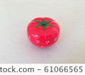 Pomodoro Timer red with green details. Tomato on the table. Vibrant, multi-angle colors. 61066565