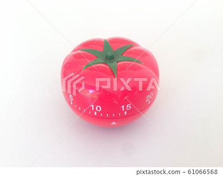 Pomodoro Timer red with green details. Tomato on the table. Vibrant, multi-angle colors. Pomodoro Timer red with green details. Tomato on the table. Vibrant, multi-angle colors. 61066568