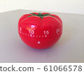 Pomodoro Timer red with green details. Tomato on the table. Vibrant, multi-angle colors. 61066578