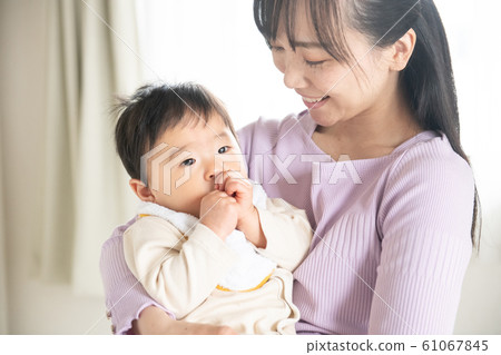 Parent and child finger sucking baby family mother child care child care play 61067845