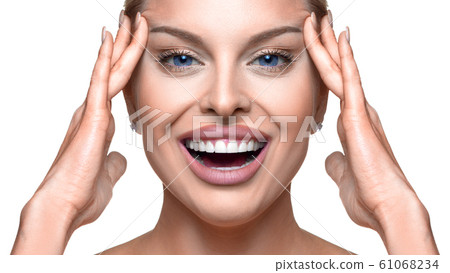 Close up portrait of a happy woman touching her face. 61068234