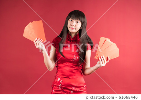 She is a flagship Qipao, and she is a red-hued Asian woman. New Year's sight. She is a flagship Qipao, and she is a red-hued Asian woman. New Year's sight. 61068446