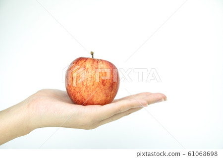 Close up red apple in hand on white isolated background 61068698