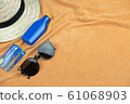 Top view of beach background. eyeglasses and credit card and sunscreen lotion and woven hats 61068903