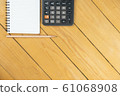 Empty notepad and calculator and pencil on wooden desk, copy space, top view background 61068908