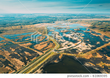Belarus. Aerial View Of Road Through Ponds In Autumn Landscape. Ponds Of Fisheries In The South Of Belarus. Top View Of Fish Farms From High Attitude. Drone View. Bird's Eye View 61069395