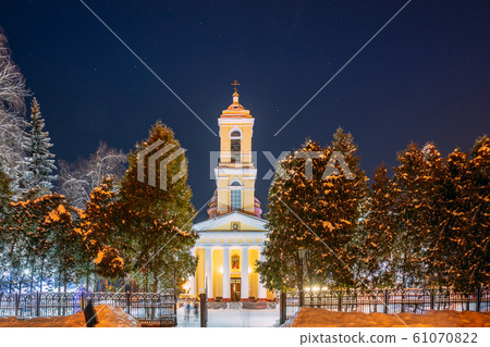 Gomel, Belarus. City Park In Winter Night. Night Starry Sky Above Peter And Paul Cathedral In Homiel Rumyantsevs And Paskeviches Park. Famous Local Landmark In Snow Gomel, Belarus. City Park In Winter Night. Night Starry Sky Above Peter And Paul Cathedral In Homiel Rumyantsevs And Paskeviches Park. Famous Local Landmark In Snow 61070822