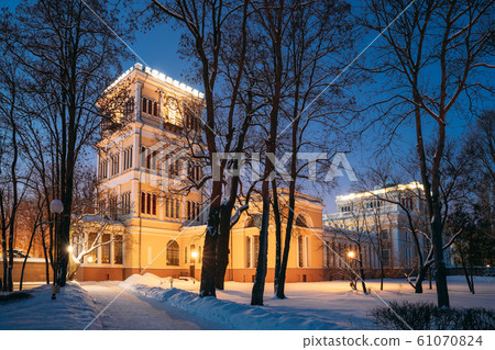 Gomel, Belarus. City Park In Winter Night. Rumyantsevs And Paskeviches Palace In Homiel Park, Belarus. Famous Local Landmark In Snow Gomel, Belarus. City Park In Winter Night. Rumyantsevs And Paskeviches Palace In Homiel Park, Belarus. Famous Local Landmark In Snow 61070824
