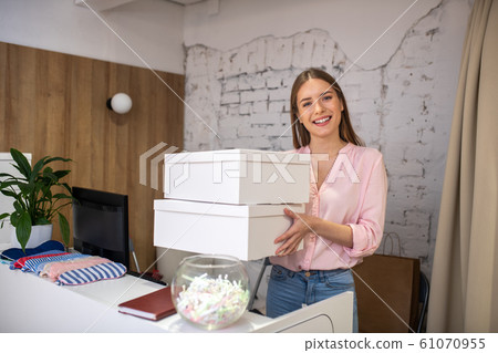 Smiling administrator holding boxes for delivery service 61070955