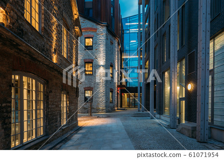 Tallinn, Estonia. Historical Rotermann City Quarter In Evening Illuminations. Rotermann Quarter Includes Old Industrial Buildings With New Function And Modern Architecture Tallinn, Estonia. Historical Rotermann City Quarter In Evening Illuminations. Rotermann Quarter Includes Old Industrial Buildings With New Function And Modern Architecture 61071954
