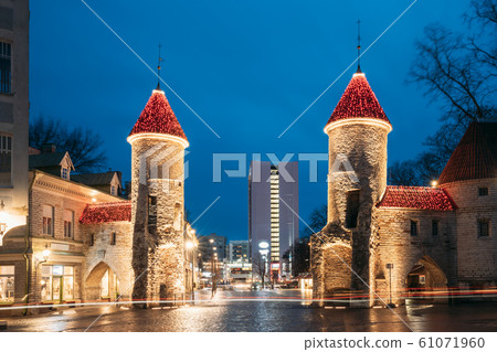 Tallinn, Estonia. Famous Landmark Viru Gate In Street Lighting At Evening Or Night Illumination. Towers In Christmas Holidays Decorations Tallinn, Estonia. Famous Landmark Viru Gate In Street Lighting At Evening Or Night Illumination. Towers In Christmas Holidays Decorations 61071960