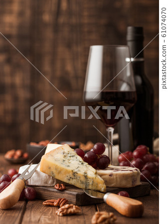 Glass and bottle of red wine with selection of Glass and bottle of red wine with selection of 61074070