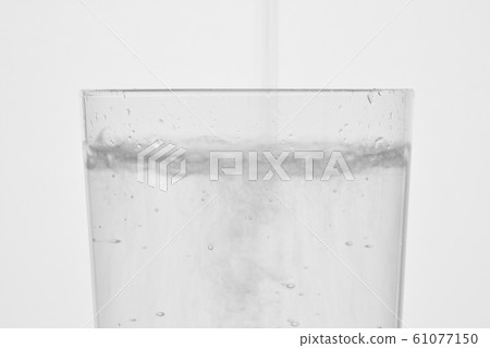Carbonated water poured into the glass Carbonated water poured into the glass 61077150