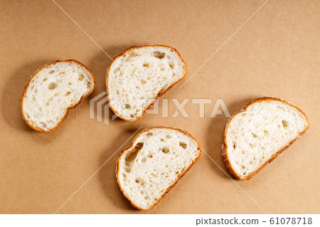 sliced whole grain bread on brown background sliced whole grain bread on brown background 61078718