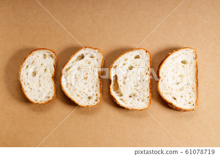 sliced whole grain bread on brown background sliced whole grain bread on brown background 61078719