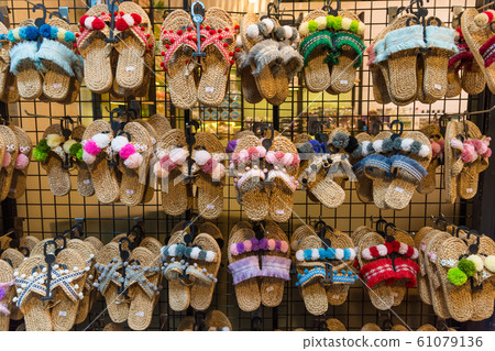 Colorful handicraft shoes selling at the market Colorful handicraft shoes selling at the market 61079136