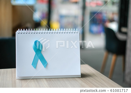 Prostate Cancer Awareness month (November), light Blue Ribbon on white paper for supporting people living and illness. Men Healthcare and World cancer day concept with copy space for your text 61081717